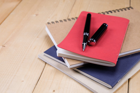 pen and book on wood backgroundの写真素材