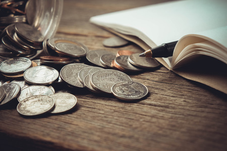 money concept coins and pen with filter effect retro vintage styleの写真素材