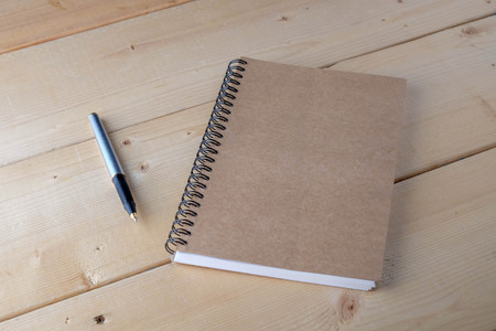 pen and book on wood backgroundの写真素材