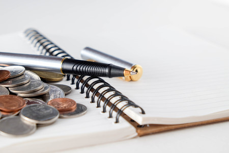 business finance. save money for investment concept coins and penの写真素材