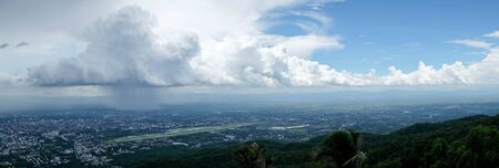 Pouring rain and dark clouds over the chiang mai city Thailandの写真素材