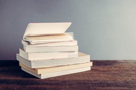 The book is on a wooden table with filter effect retro vintage style