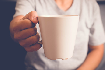 Women hold a coffee cup with filter effect retro vintage styleの写真素材