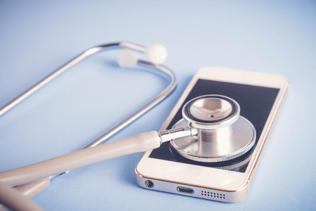 Medical equipment stethoscope and mobile with filter effect retro vintage styleの写真素材