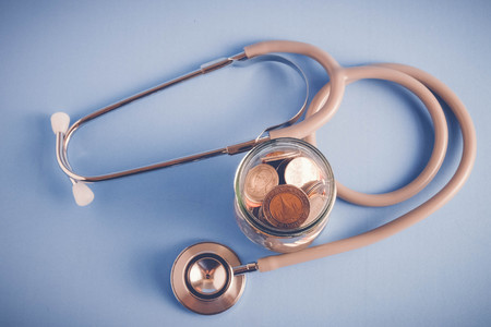 save money for investment concept Stethoscope and money  with filter effect retro vintage styleの写真素材