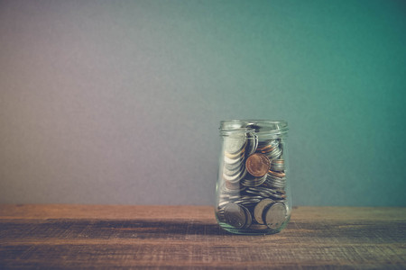 save money for investment concept money in the glass jar with filter effect retro vintage style