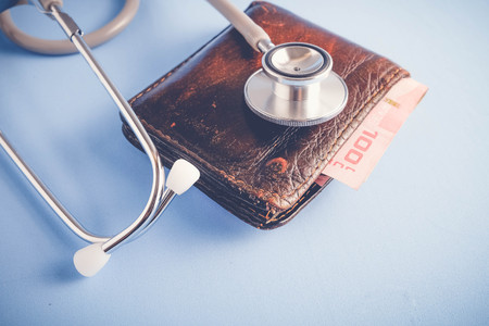 save money for investment concept Stethoscope and money  with filter effect retro vintage style