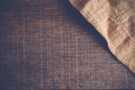 Wood table with old sackcloth burlap tablecloth texture with filter effect retro vintage styleの写真素材