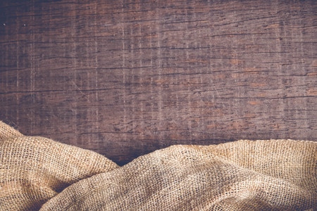 Wood table with old sackcloth burlap tablecloth texture with filter effect retro vintage styleの写真素材