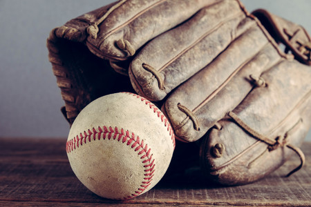 old Baseball and glove on wood background with filter effect retro vintage styleの写真素材
