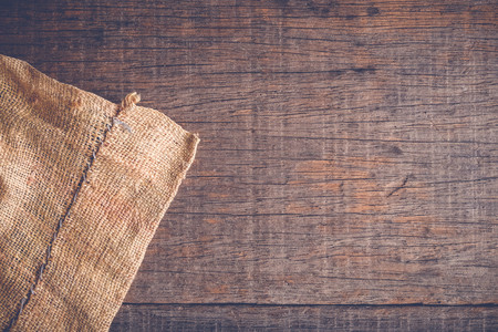 Wood table with old sackcloth burlap tablecloth texture with filter effect retro vintage styleの写真素材