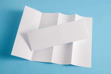 template fold white paper on blue backgroundの写真素材