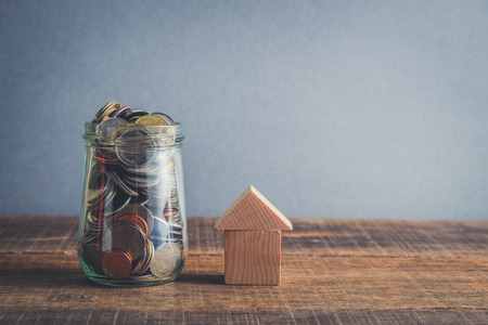 save money for investment mortgage concept by money house from a coins with filter effect retro...