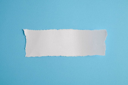 white torn paper with blue background, ready for designの写真素材