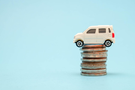 save money for investment concept Toy car and stack of coinsの写真素材