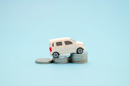 save money for investment concept Toy car and stack of coins
