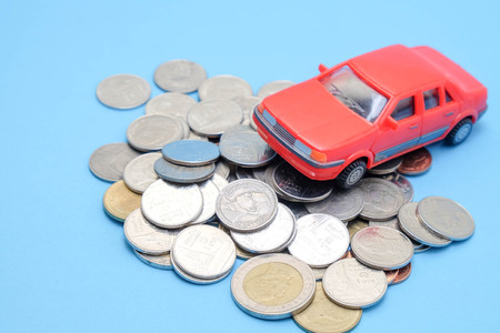 save money for investment concept Toy car and stack of coinsの写真素材