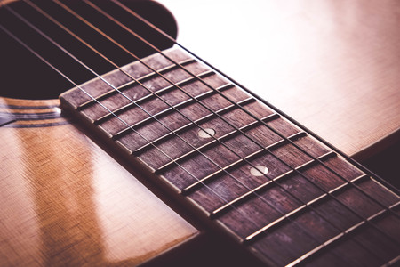 Close Up shot photo of Classic acoustic guitar with filter effect retro vintage style