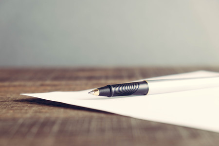 pen and paper on wood background with filter effect retro vintage styleの写真素材