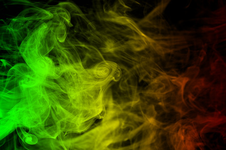 abstract background smoke curves and wave reggae colors green, yellow, red colored in flag of reggae musicの写真素材