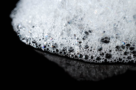 Abstract background white soapy foam texture. Shampoo foam with bubblesの写真素材