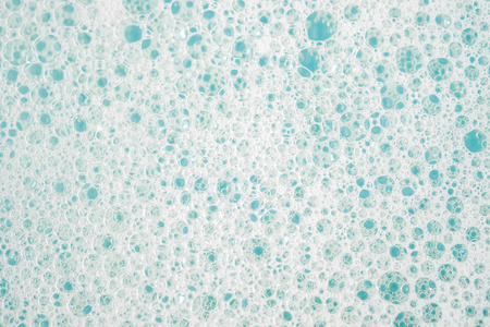 Abstract background white soapy foam texture. Shampoo foam with bubblesの写真素材