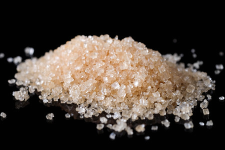 Crystals Sugar,Brown cane sugar isolated on black backgroundの写真素材