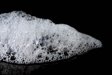 Abstract background white soapy foam texture. Shampoo foam with bubblesの写真素材
