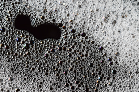 Abstract background white soapy foam texture. Shampoo foam with bubblesの写真素材
