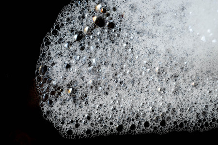 Abstract background white soapy foam texture. Shampoo foam with bubblesの写真素材