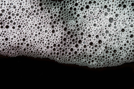 Abstract background white soapy foam texture. Shampoo foam with bubblesの写真素材