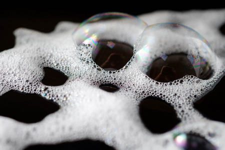 Abstract background white soapy foam texture. Shampoo foam with bubblesの写真素材