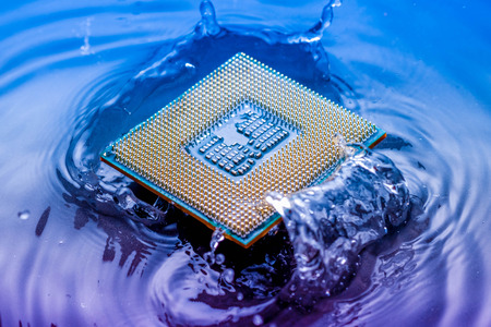 technology cyber electronic concept. cpu ram computer Fall into the water on blue light background. CPU cooling with waterの写真素材