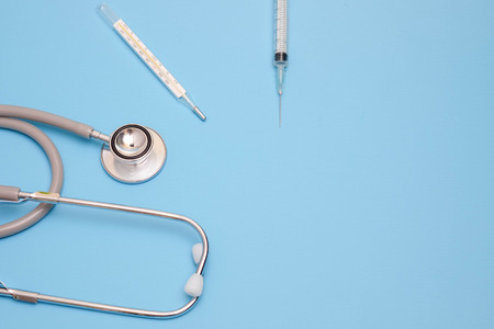 Stethoscope, medical instrument on blue background