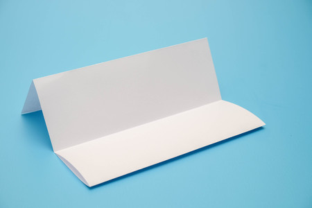 template fold white paper on blue backgroundの写真素材