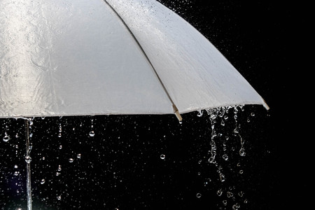 Wet protection umbrella in stormy weather with natural thunderstorm, on black background,の写真素材