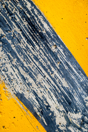 Yellow striped road markings on black asphaltの写真素材
