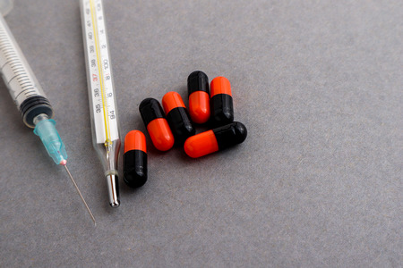 Medical equipments including syringe, drug medicines background, top view flat lay