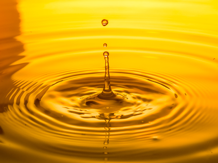 close up of a drop oil on a yellow backgroundの写真素材