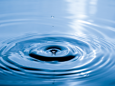 close up drop of water on blue background