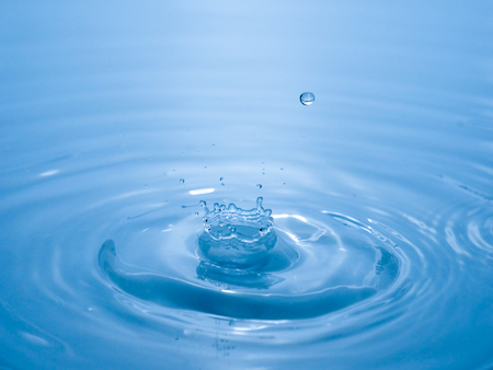 close up drop of water on blue backgroundの写真素材