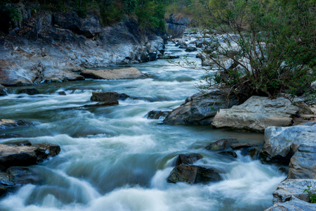 creek flowing over the rocksの写真素材