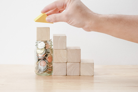 save money for investment mortgage concept by wood block houseの写真素材