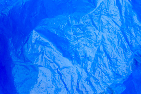 Abstract background crumpled plastic film texture blue garbage bagの写真素材