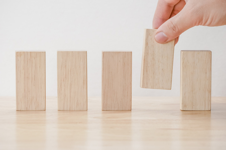 business finance. growing Profit concept,Hand arranging wood blockの写真素材