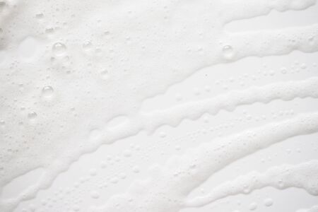 Abstract background white soapy foam texture. Shampoo foam with bubblesの写真素材