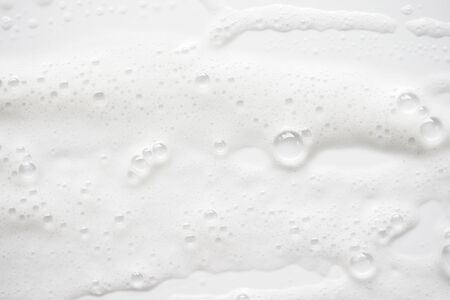 Abstract background white soapy foam texture. Shampoo foam with bubblesの写真素材