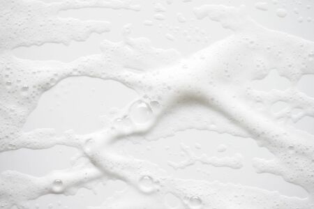 Abstract background white soapy foam texture. Shampoo foam with bubblesの写真素材