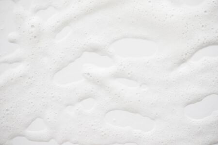 Abstract background white soapy foam texture. Shampoo foam with bubblesの写真素材