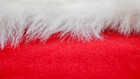 red and white fabric christmas background, red cloth and soft white furの写真素材